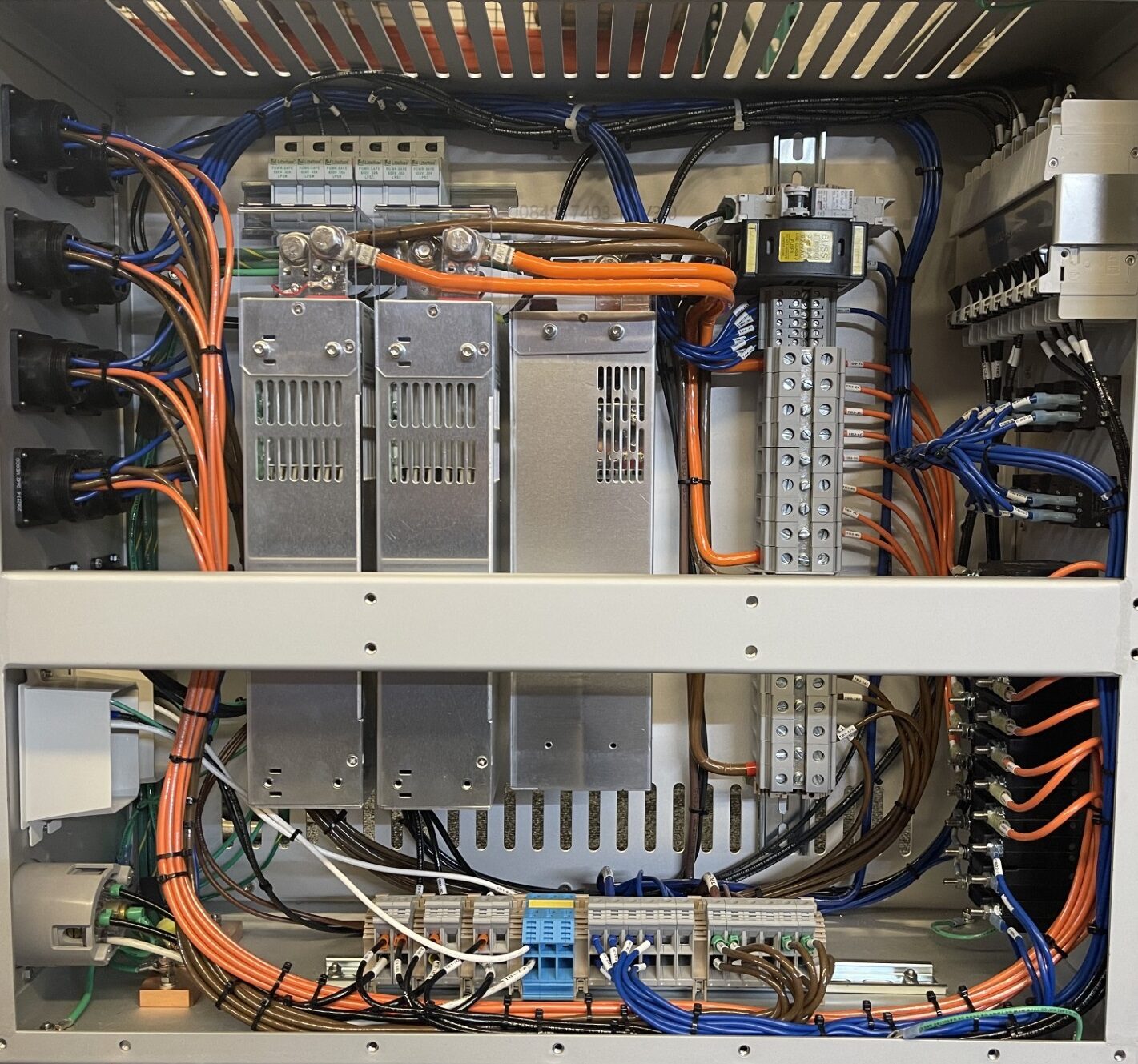 Open rack mount electro mechanical enclosure showing labeled relay banks and wiring