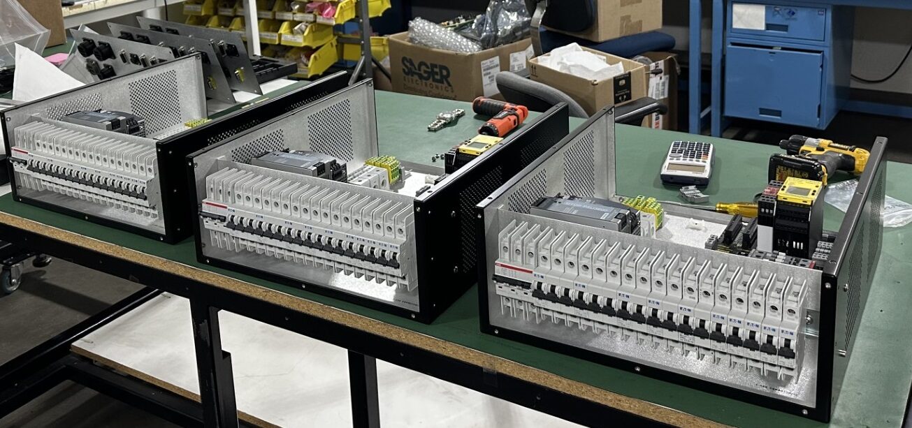 Row of rack mounted enclosures with circuit breakers, built by HPN Electronics